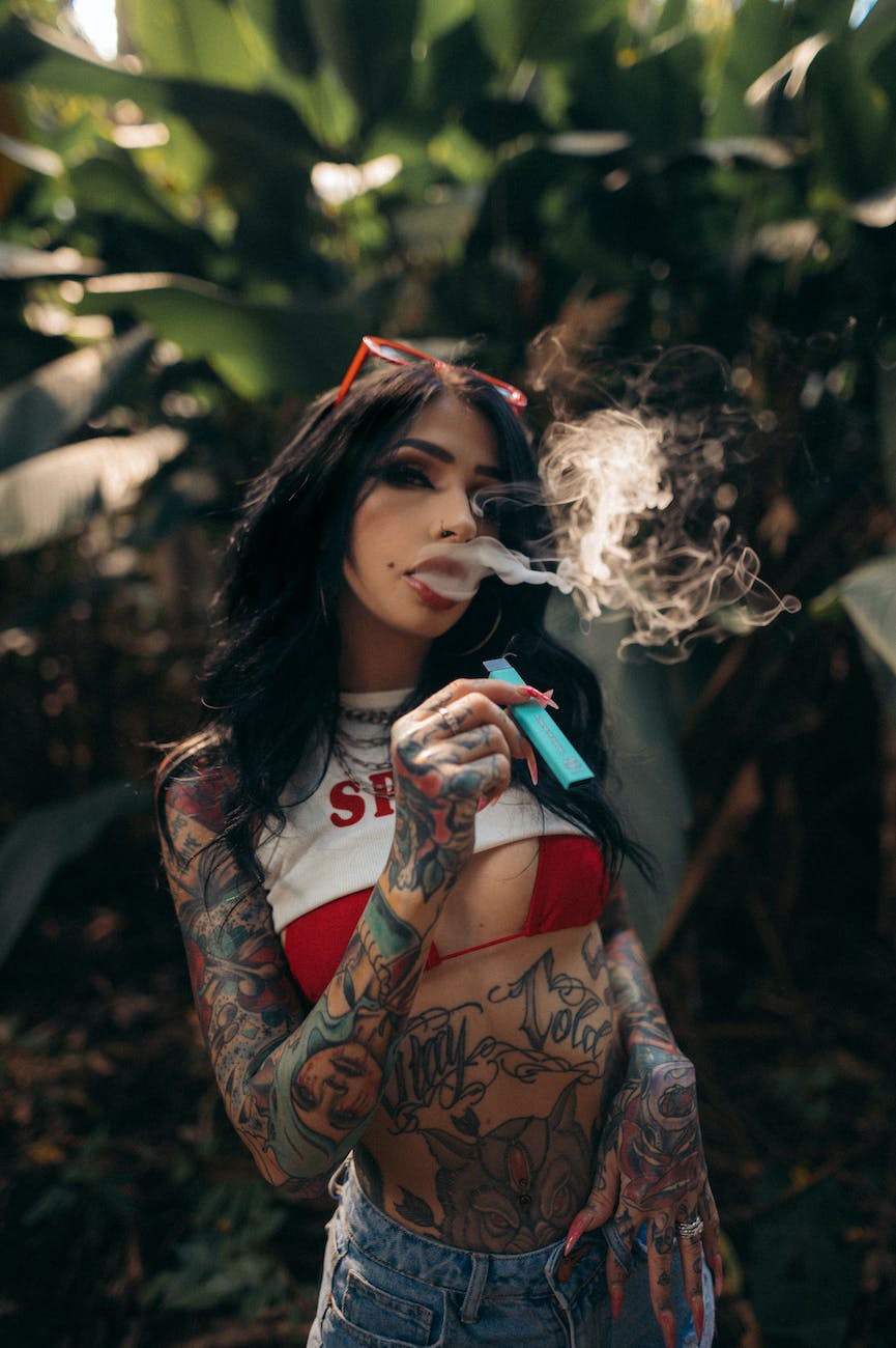 pexels-photo-11921813 The State digest woman in black and red floral long sleeve shirt smoking | E-Cigarette advertising and using is danger and cause cancer | India Banned E-Cigarette