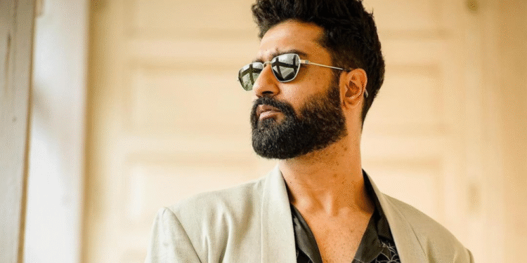 Vicky Kaushal wearing sunglasses and a beige blazer, looking away confidently.